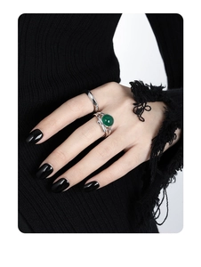 Close-up of minimalist S925 sterling silver wavy ring with green cabochon gemstone