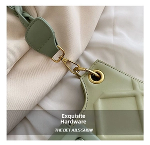 Detail of light green quilted leather bag featuring gold-tone lobster clasp hardware