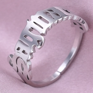 Macro detail of silver stainless steel adjustable ring with gothic babygirl cutout design