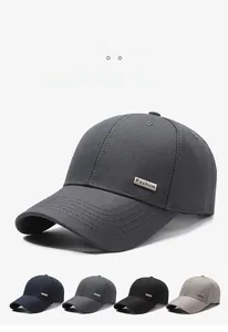 Detailed view of the woven fabric texture and metal fashion emblem on a men's baseball cap