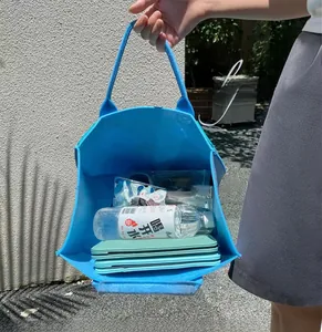 Interior view of spacious electric blue felt tote bag filled with travel essentials