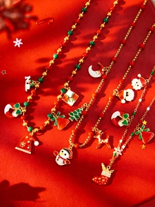 Flat lay of colorful Christmas themed necklaces with snowman, bell, and deer pendants