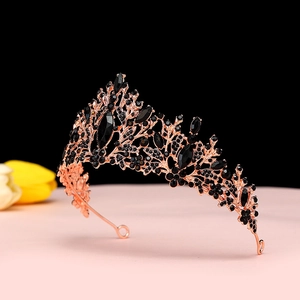 Close-up of vintage rose gold crown with black crystals and branch-like pattern