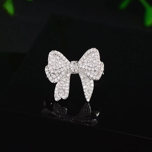 Elegant silver bow brooch with sparkling cubic zirconia crystals for women's fashion