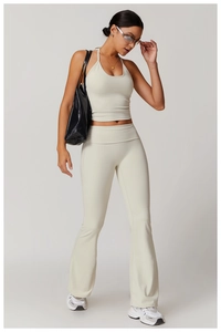 Détail de l'ensemble de yoga avec haut dos nu et pantalon évasé en tissu blanc os