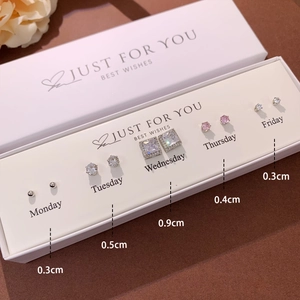 Detail of S925 silver stud earring set with heart shapes and zircons in a white gift box