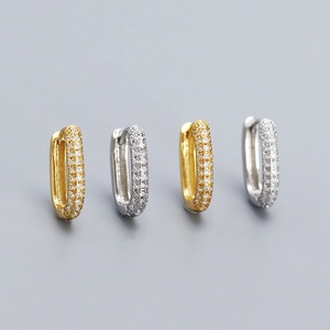 Close-up of gold and silver S925 sterling silver hoop earrings with pavé cubic zirconia