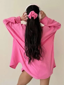 Detail of rose pink textured long sleeve shirt back and matching hair scrunchie accessory