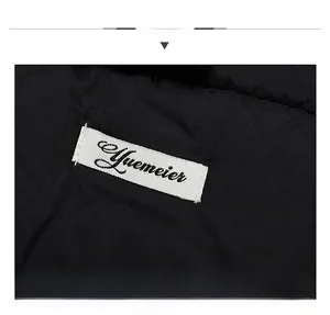 Macro view showing the brand label and fabric texture of a black winter thermal hat