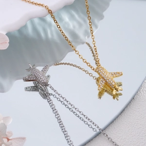 Sparkling airplane pendant necklaces in gold and silver with zircon pave stones