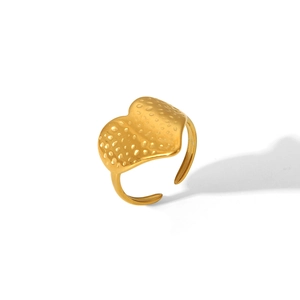 Macro shot of gold adjustable ring featuring irregular wavy hammered metal texture