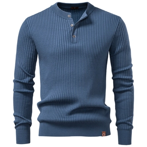 Detail of blue knitted Henley shirt with vertical texture and decorative leather patch