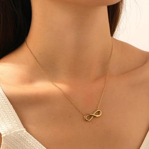 Minimalist gold-plated stainless steel infinity symbol necklace worn by a female model