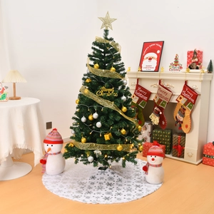 Detailed Christmas tree setup featuring golden ornaments and white plush sequin tree skirt