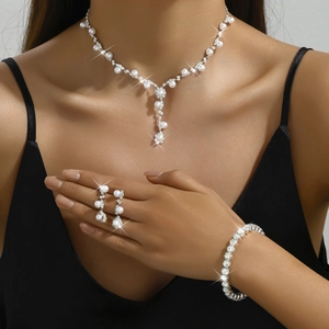 Model wearing elegant silver jewelry set with white pearls and sparkling rhinestones
