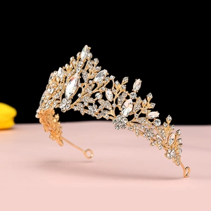Detailed macro view of the intricate golden alloy leaf patterns and sparkling crystals