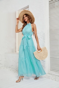 Close-up of light blue checkered maxi dress with halter neck and tiered ruffle hem detail
