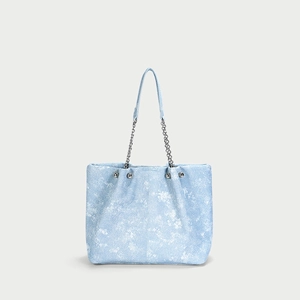 Blue denim texture tote bag with white floral pattern and silver chain handle