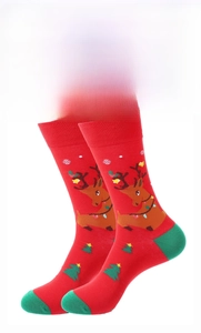 Detail of red Christmas crew socks featuring reindeer pattern and green toe accents