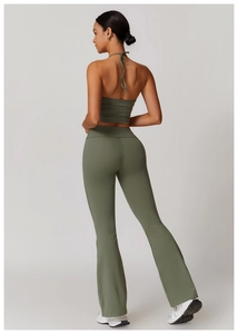 Detail view of olive green halter yoga top and high-waist flared pants from the back