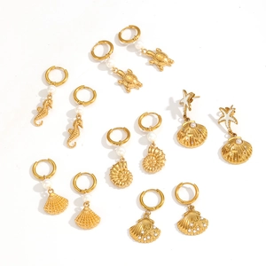 Gold ocean themed earring set featuring sea turtles and shells with pearls