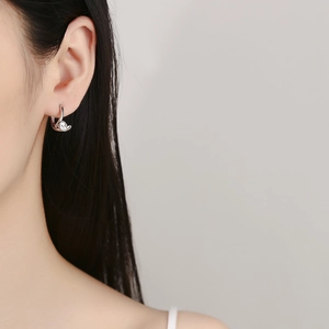 Elegant 925 sterling silver hoop earrings with round zircon on female model's ear