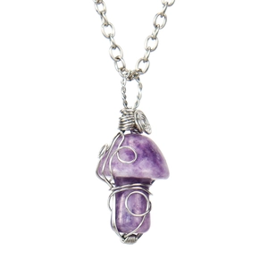 Detailed macro view of handmade purple crystal mushroom pendant with silver wire wrap
