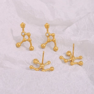 Detailed close-up of 18K gold plated constellation earrings with sparkling diamond studs