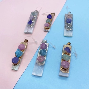 Detail of rectangular white stone pendant with three colorful raw crystal mineral stones