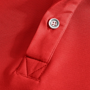 Detail view of red piqué polo shirt fabric featuring a white resin button and placket