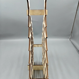 Detail view showing laser-cut wood layers and hollow structure of tree wine rack