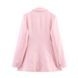 Rear view of pink double-breasted blazer showing structured shoulders and gold cuff buttons