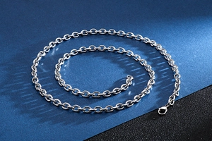 Macro shot of a spiraled silver stainless steel cross O-chain necklace for men and women