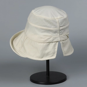 Detail of off-white sun hat showing pleated layers and ponytail opening in the back