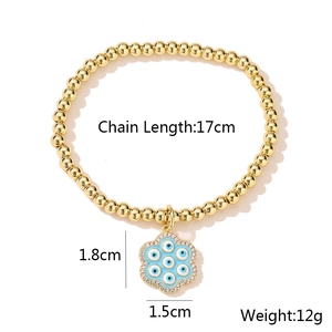 Close-up of 18K gold plated beaded bracelet with blue evil eye pendant and size details