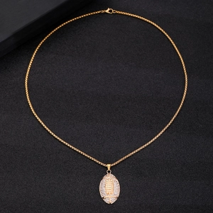 Hip hop gold plated necklace featuring an American football pendant with white rhinestones