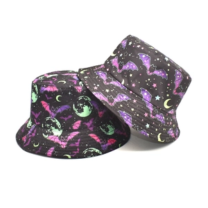 Detail view of cotton bucket hat with purple bat, green moon and pink star patterns