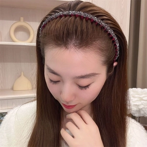 Deep red headband with silver rhinestones on a model, showing the elegant sparkle