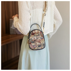 Detail of printed fabric crossbody bag with teddy bear pattern and wide strap