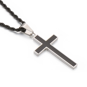 Minimalist black cross pendant necklace with silver metal trim on a black woven cord