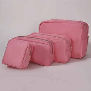 Detail set of four pink nylon cosmetic bags with durable gold zippers for travel