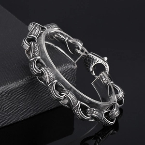 Retro stainless steel men's chain bracelet with textured links and industrial design