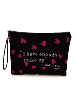 Detail of black makeup bag with pink heart and humorous English quote print