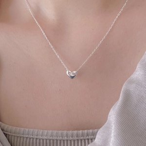 Minimalist 925 sterling silver heart pendant necklace worn on neck with ribbed top