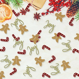 Christmas confetti with gingerbread man, gold Joy glitter, and candy cane on plush background