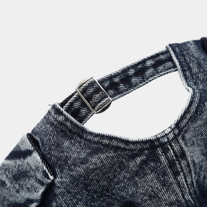 Detail of adjustable metal buckle and acid-wash denim strap on retro brimless docker cap