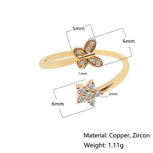 Adjustable gold flower and butterfly ring with sparkling cubic zirconia accents