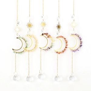 Detail of moon suncatchers with natural stones and multifaceted crystal pendants