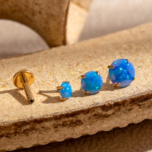 Set of 4 gold stainless steel labret studs with 4-prong set blue fire opal stones