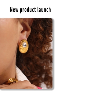 Close-up of gold bird nest texture earrings and ring set with clear zircon stones